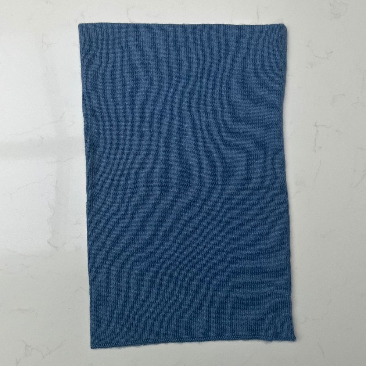 A pretty mid blue 100% cashmere Saddle Creek snood which is approx 16" long and 10" wide