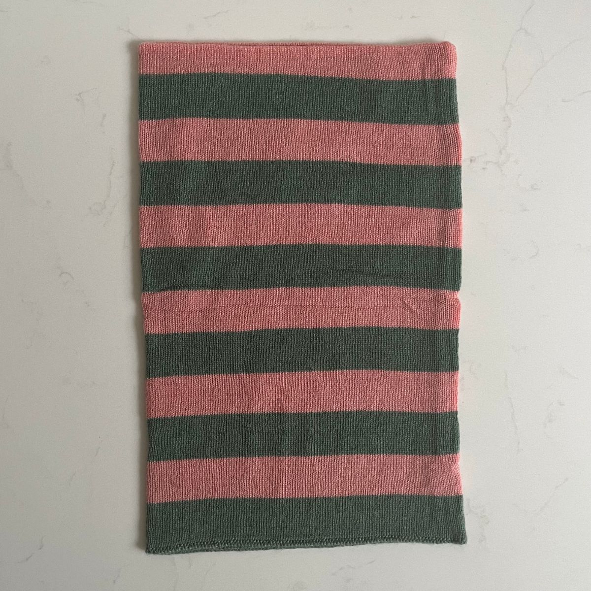 A pretty soft sea green and corally pink striped Saddle Creek 100% cashmere snood which is reversible and approx 16" long and 10" wide. The reverse is a plain sea green colour. Can be worn either way to keep your neck cosy warm