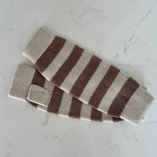 Pair of Saddle Creek striped fingerless cashmere gloves in an oatmeal and cocoa brown stripe on a light marble background