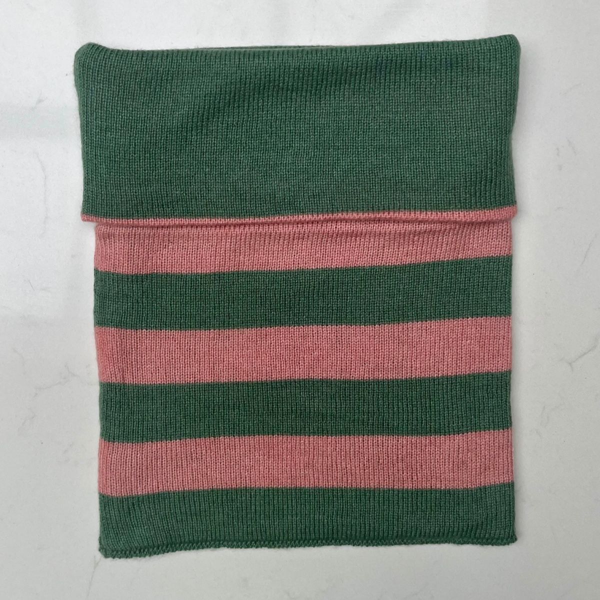 A pretty soft sea green and corally pink striped Saddle Creek 100% cashmere snood which is reversible and approx 16" long and 10" wide. The reverse is  a plain sea green colour. Can be worn either way to keep your neck cosy warm