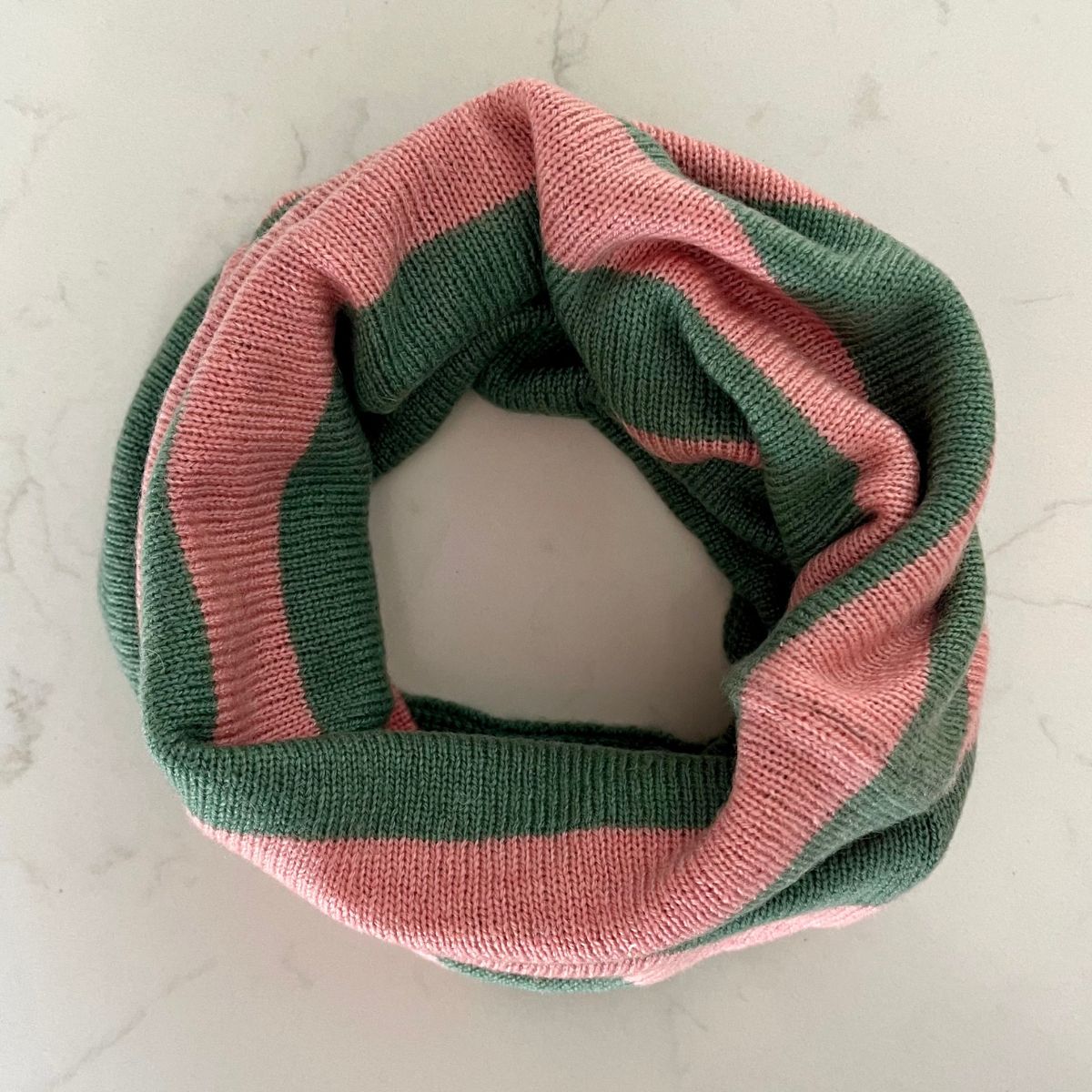 A pretty soft sea green and corally pink striped Saddle Creek 100% cashmere snood which is reversible and approx 16" long and 10" wide. The reverse is  a plain sea green colour. Can be worn either way to keep your neck cosy warm